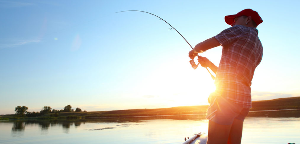 man on boat angliing with fishing rod | Different Angling Techniques | Fraziers Guide Service Blog